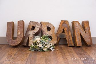 Flower bouquet in front of large, vintage letters that spell "urban"