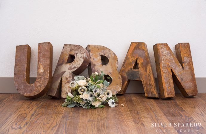 Flower bouquet in front of large, vintage letters that spell 