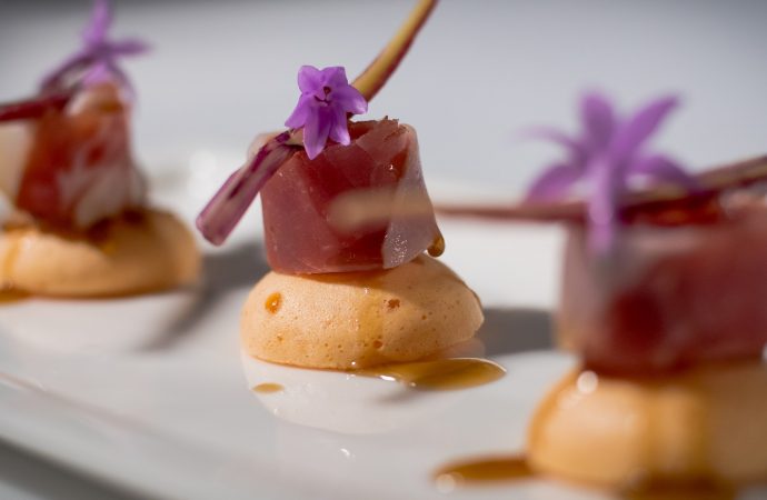 Small deserts with glaze and purple flower toppings