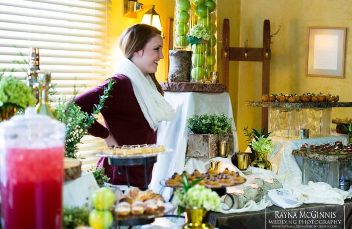 Woman standing behind table of food