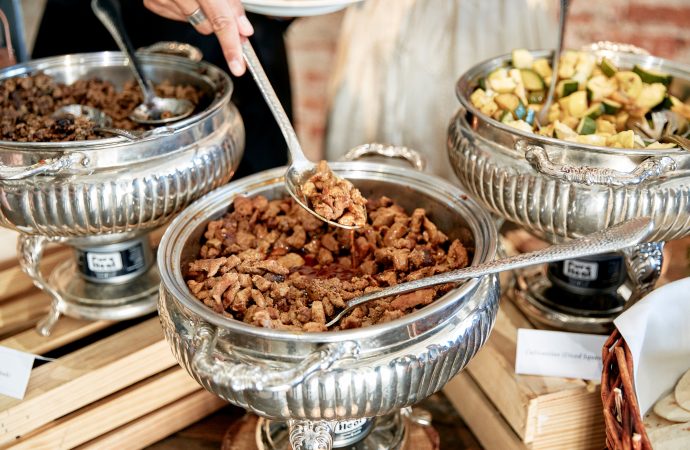 Mixed vegetables and bowl of meat on display at a buffet