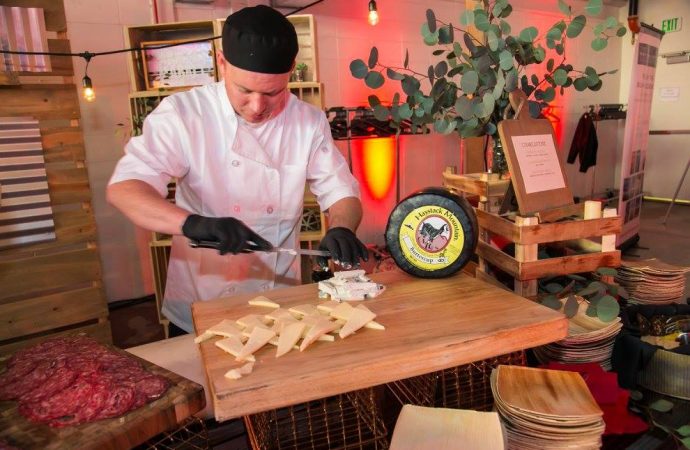 man cutting cheese