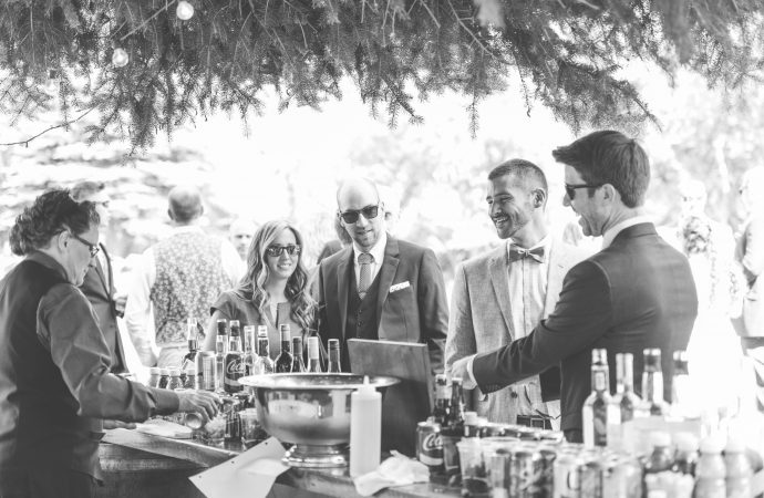 People standing at a bar at an event getting drinks