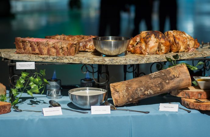 Various slabs of meat on a granite display setting on a buffet