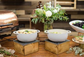 Serving dishes full of food on a decorated event table