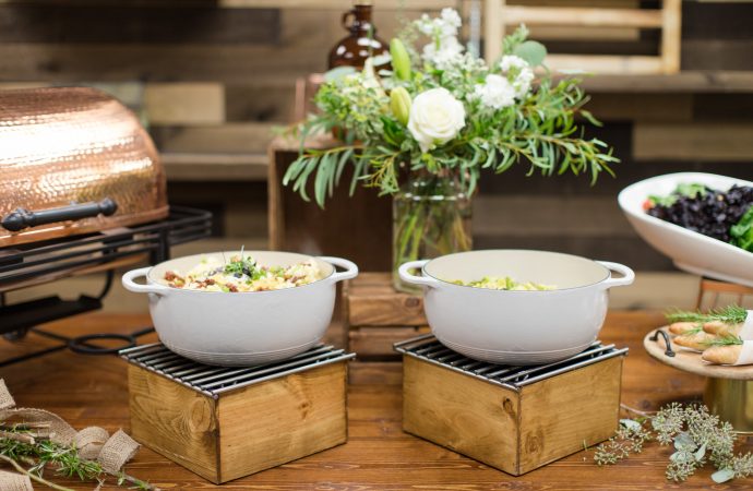 Serving dishes full of food on a decorated event table