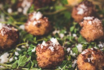 Tray of single-serve appetizers on bed of greens