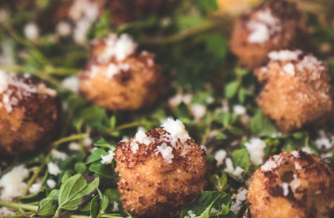 Tray of single-serve appetizers on bed of greens