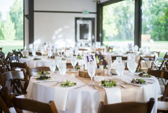 Wedding table with plated salads in brightly lit room