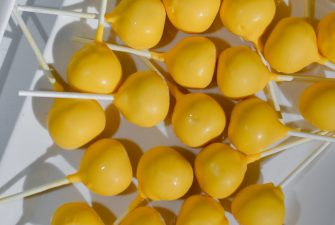 Plate of yellow dipped cake pops