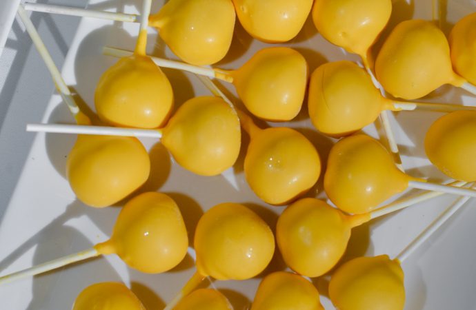 Plate of yellow dipped cake pops