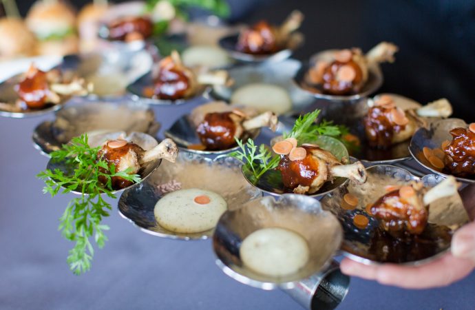 Person passing a tray of appetizer