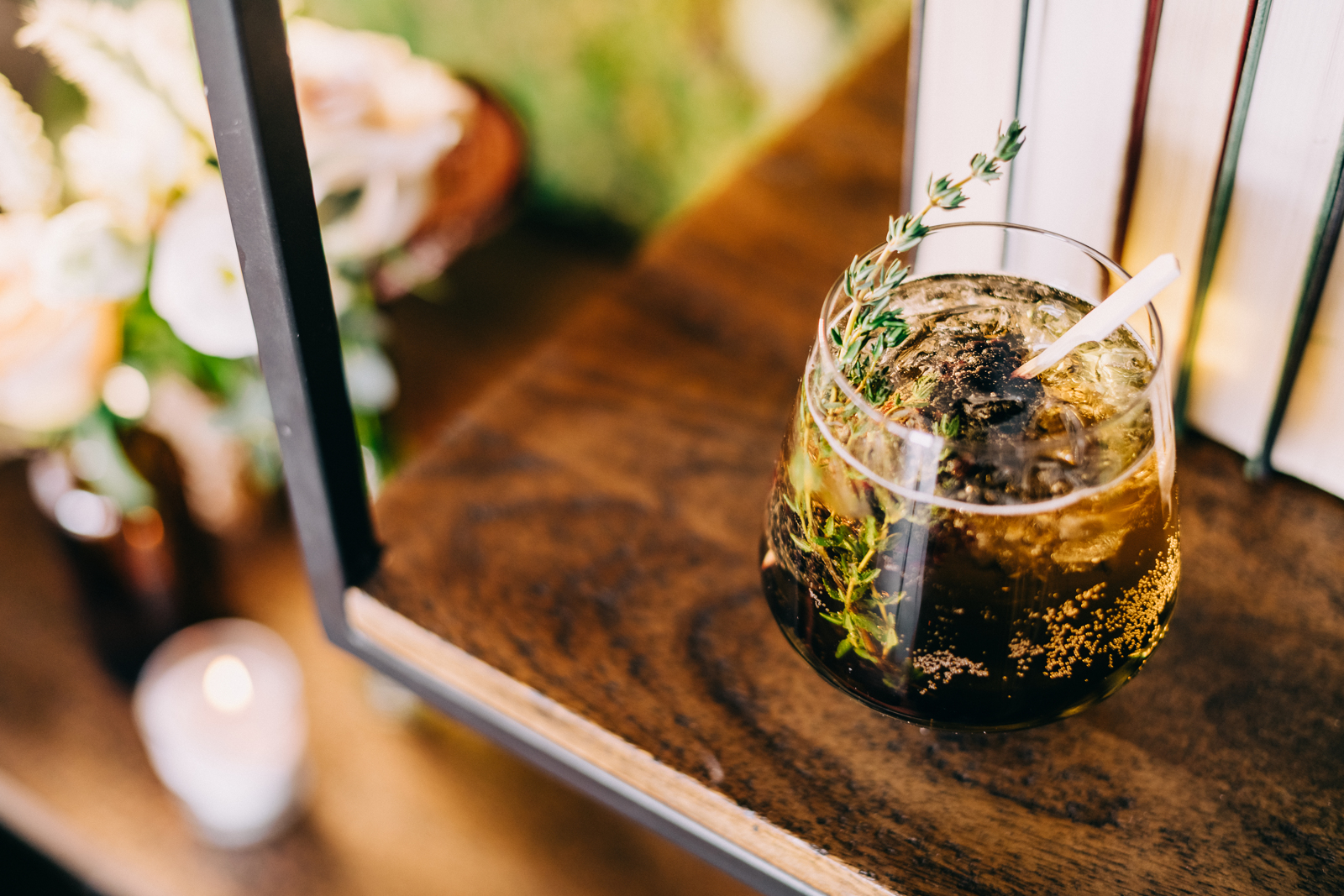 close up of cocktail with thyme stem