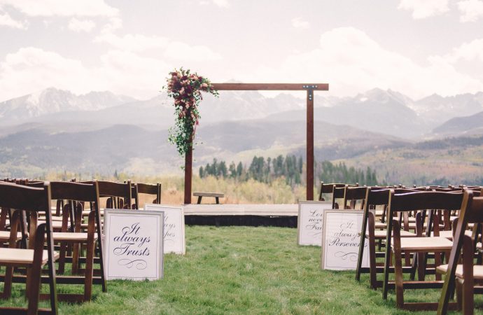 Outdoor wedding setup with wooden archway in the Rocky Mountains
