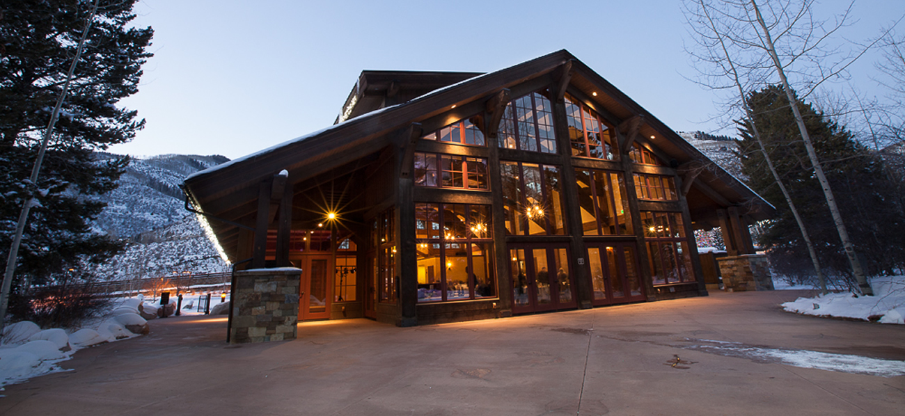 Exterior of large A-frame lodge at twilight