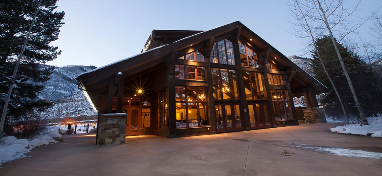Exterior of large A-frame lodge at twilight