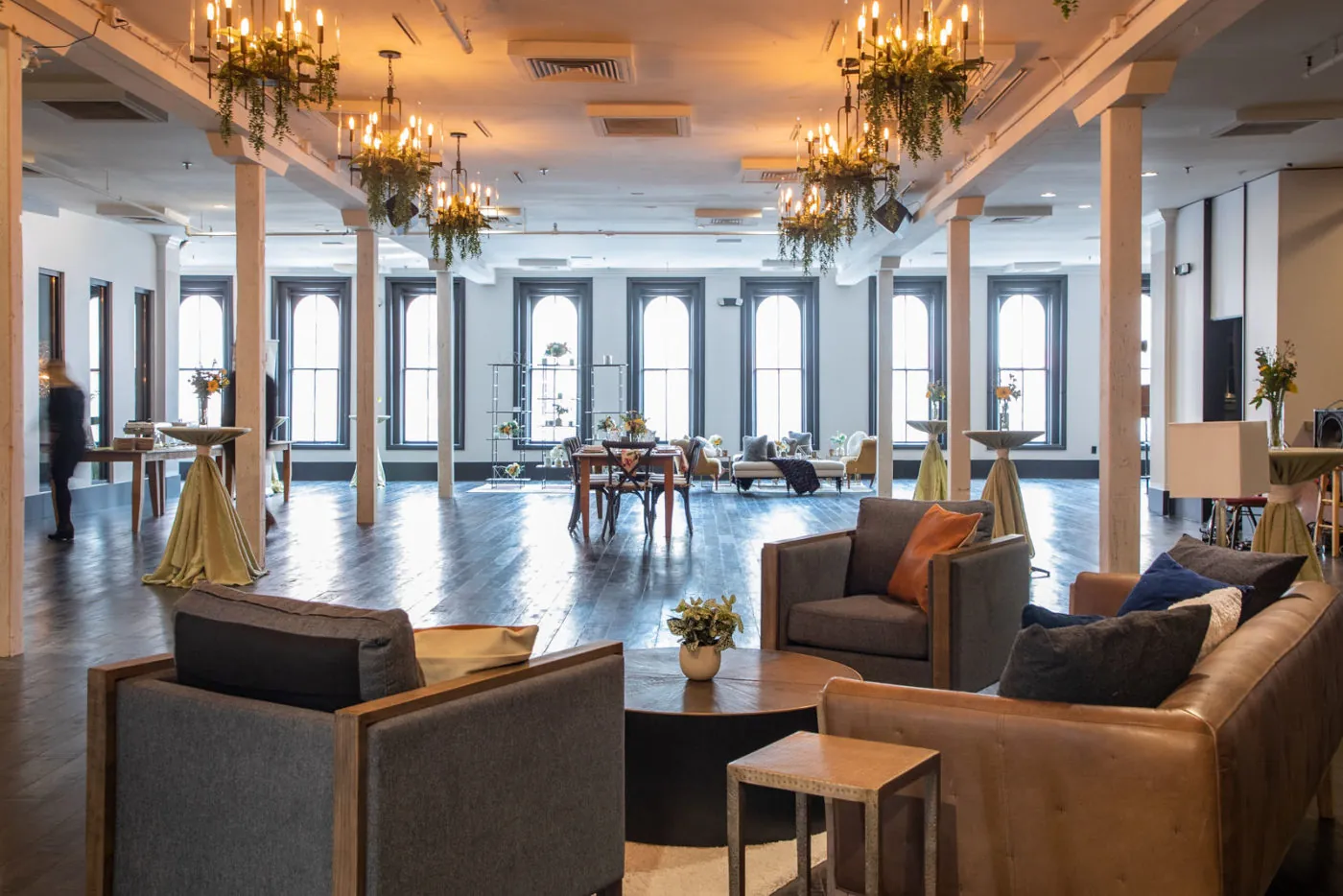Open event space with chairs and chandeliers