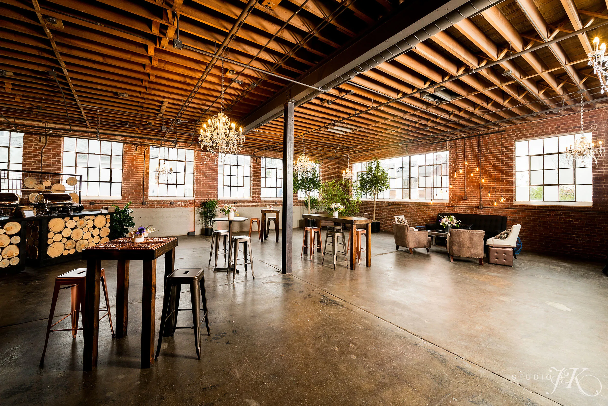 Open interior event space with brick walls and wood beams