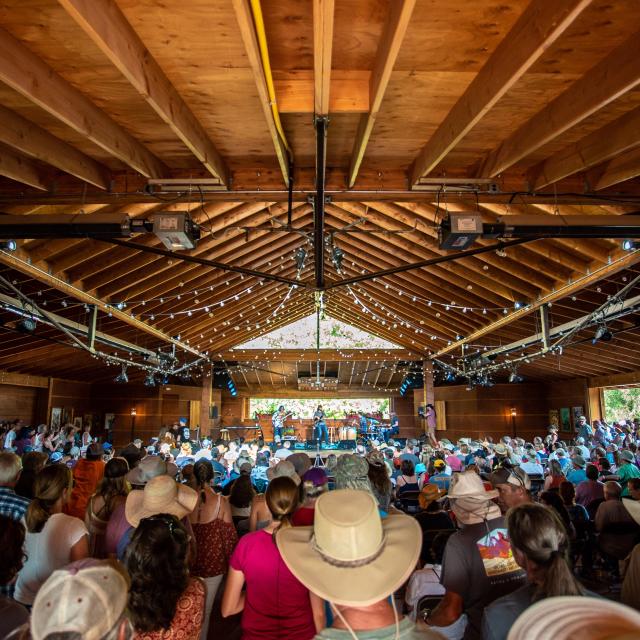 Large open venue with wood roof and string lights
