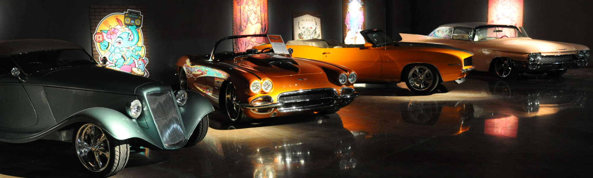 Gallery of vintage cars under spotlights