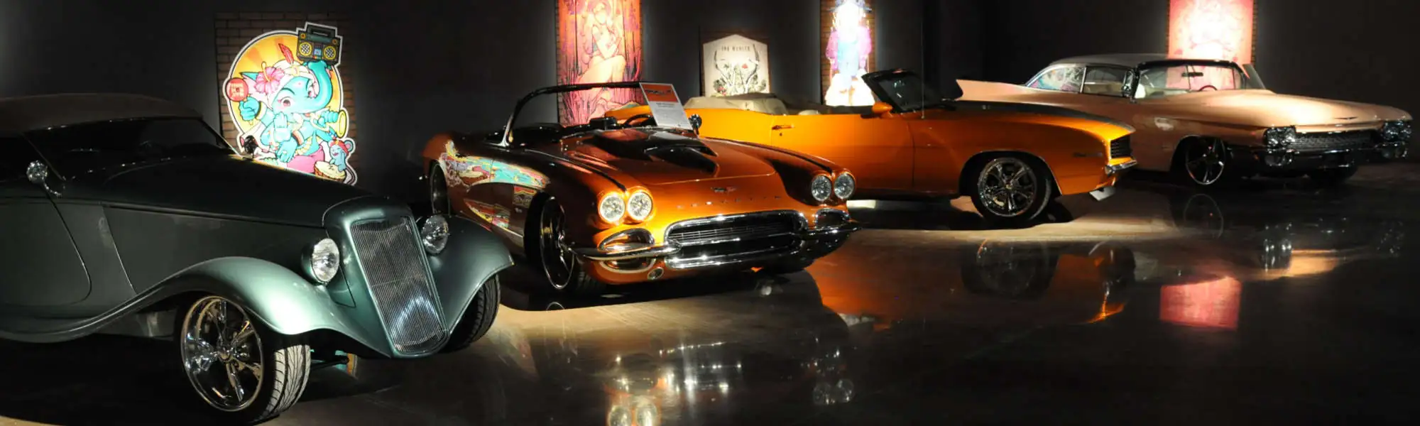 Gallery of vintage cars under spotlights