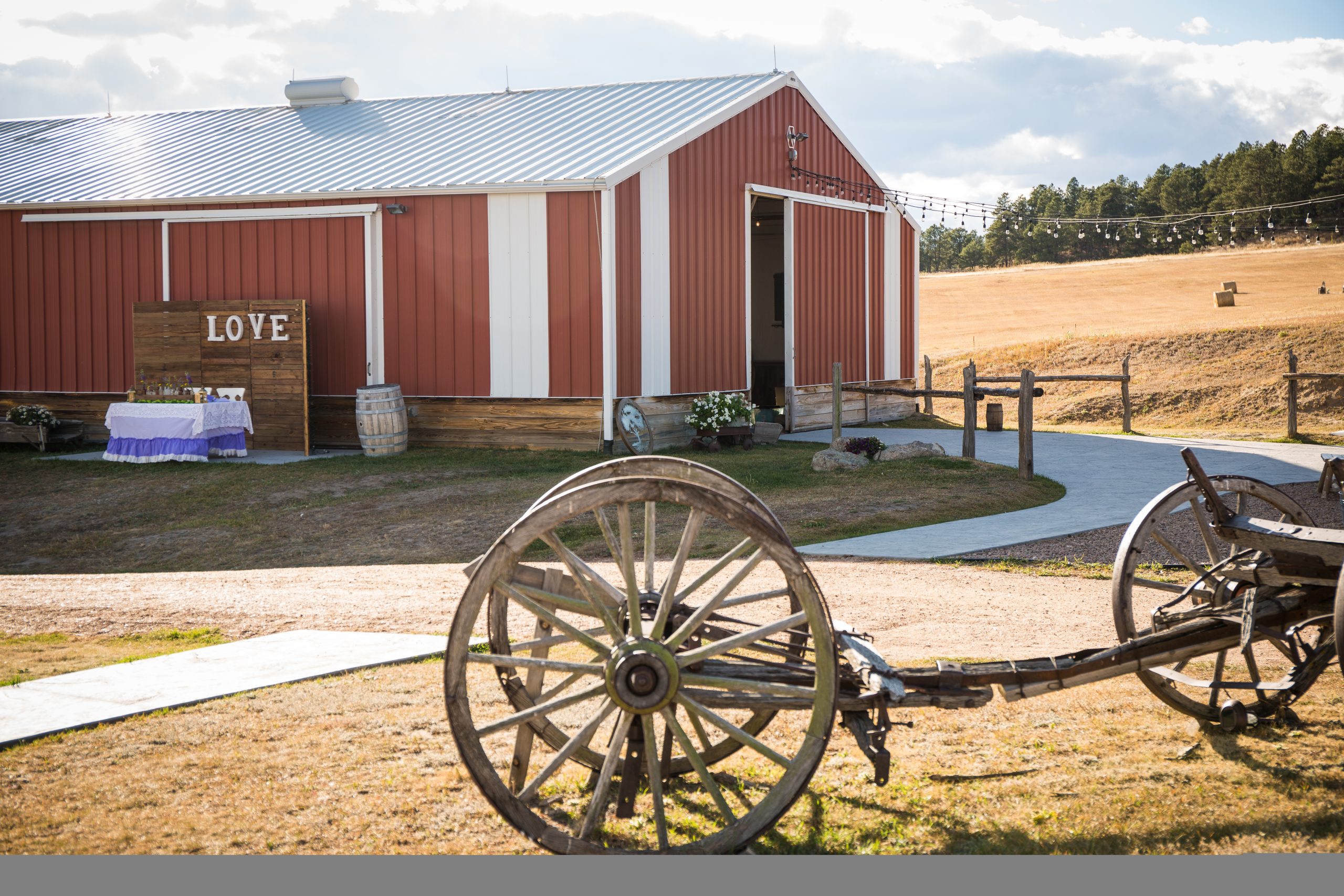 Red barn in the country with old style plow and decorations