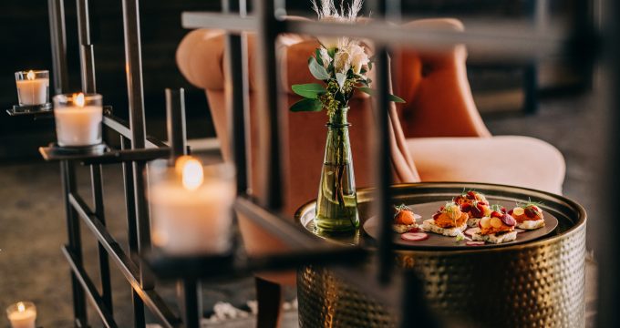 appetizers and floral bouquet framed by candelabra