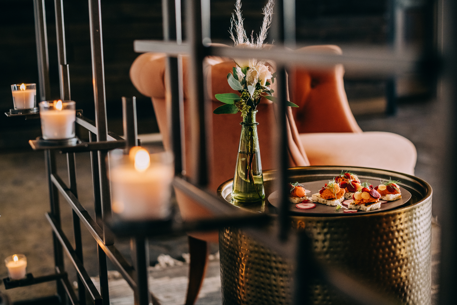 appetizers and floral bouquet framed by candelabra