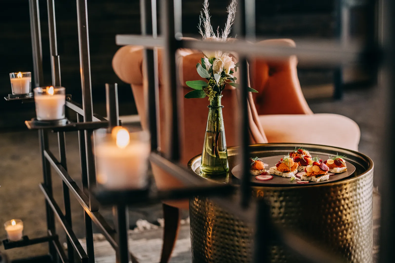 appetizers and floral bouquet framed by candelabra