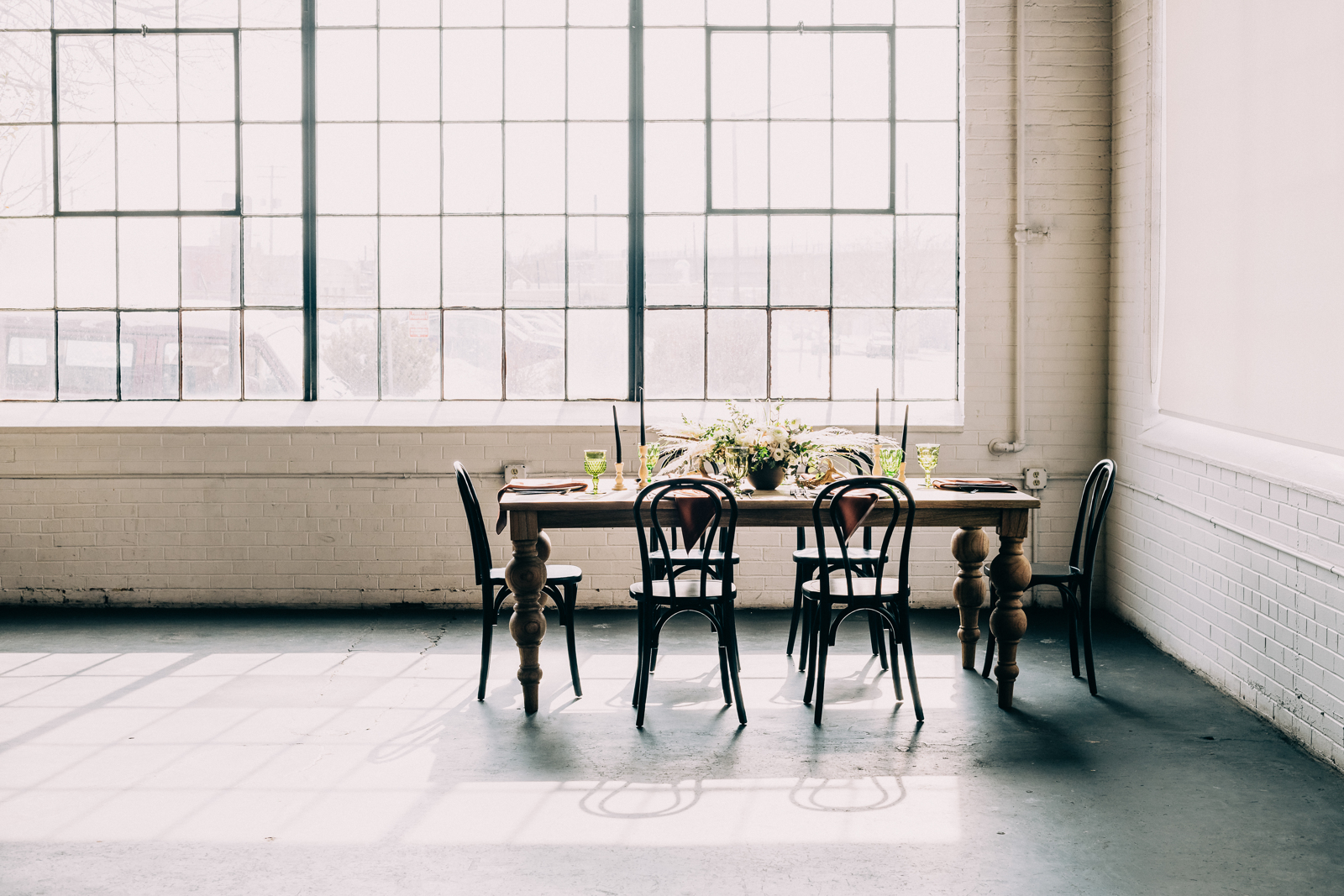 broad shot of set table with large window behind it