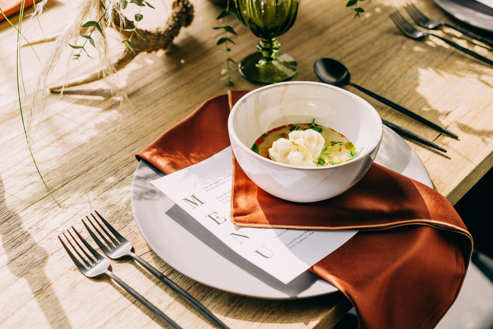 dumpling soup on plate with menu underneath it