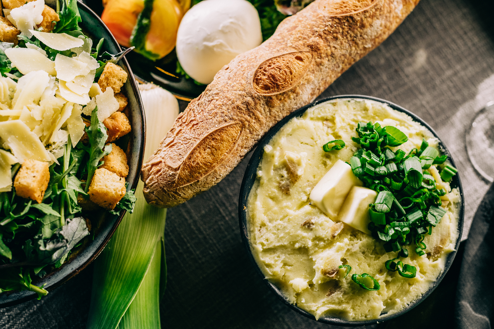 mashed potatoes, Caesar salad and baguette