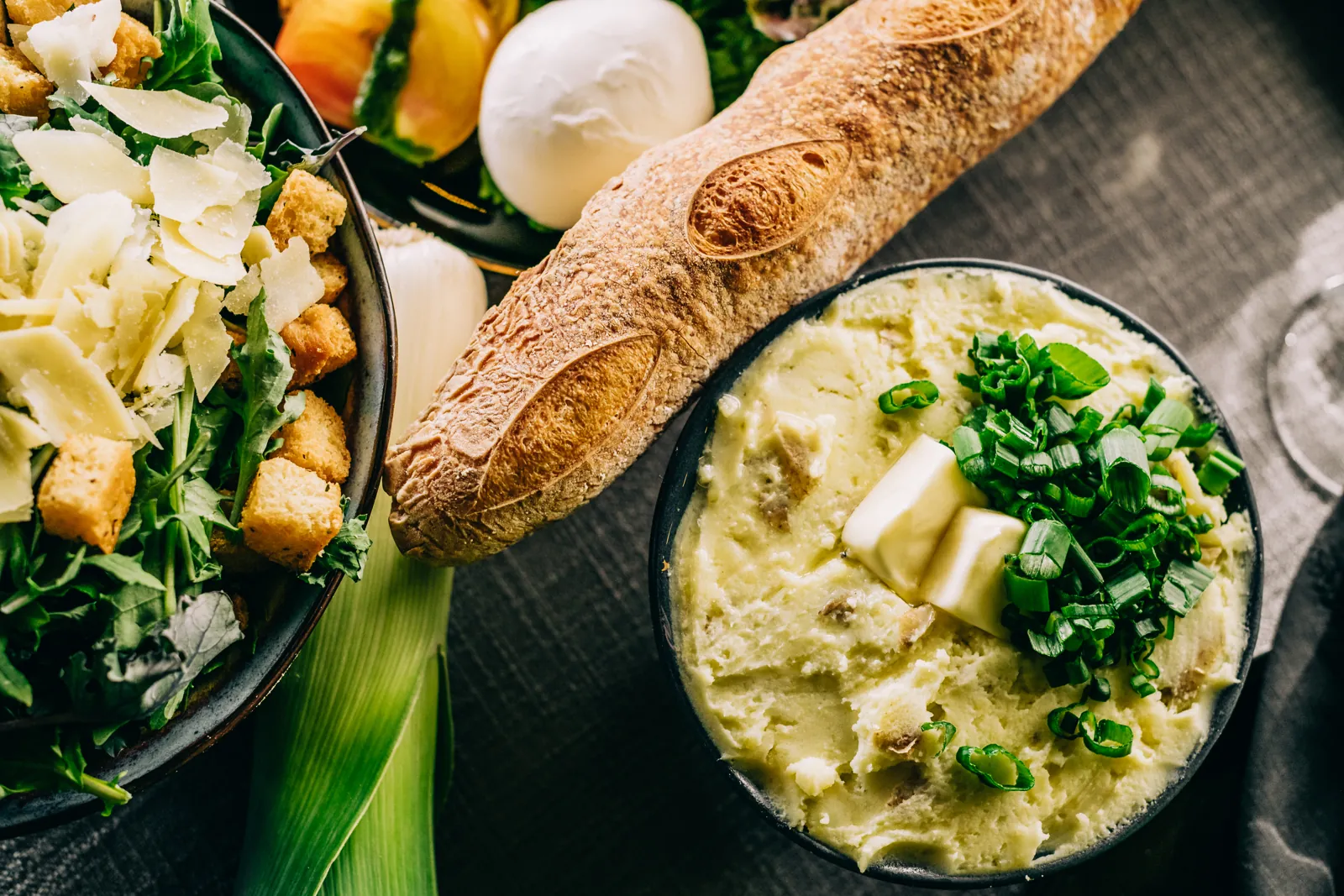 mashed potatoes, Caesar salad and baguette