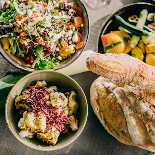 overhead shot spread of bread and salads