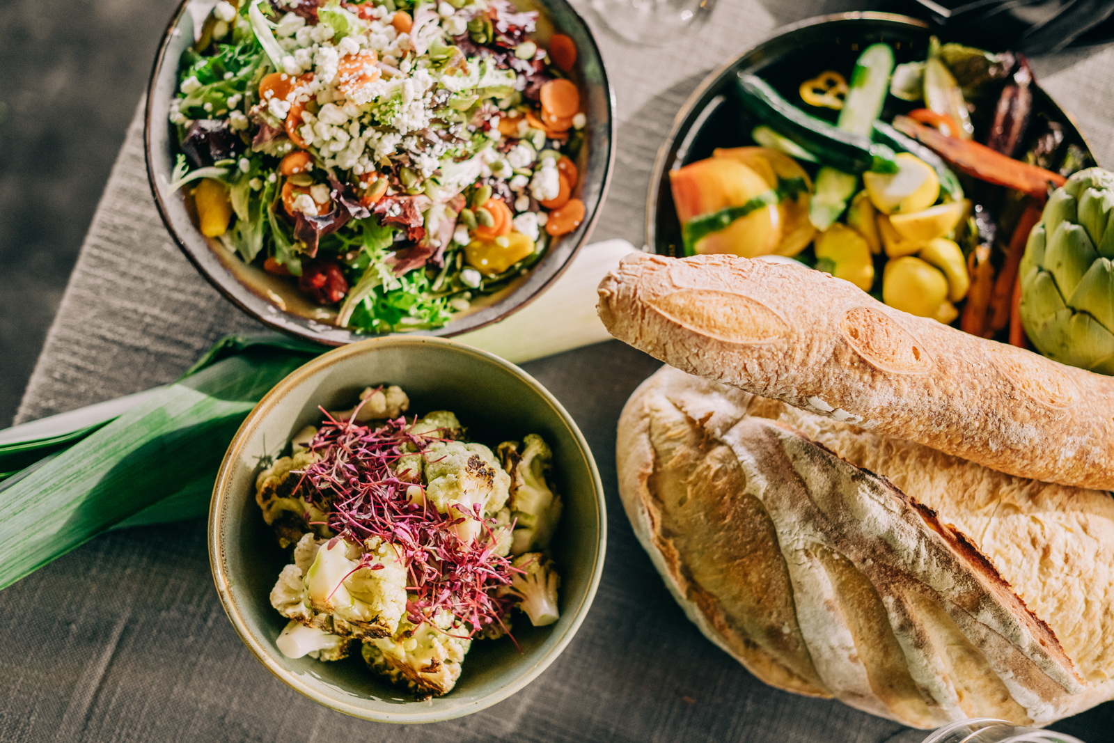 overhead shot spread of bread and salads