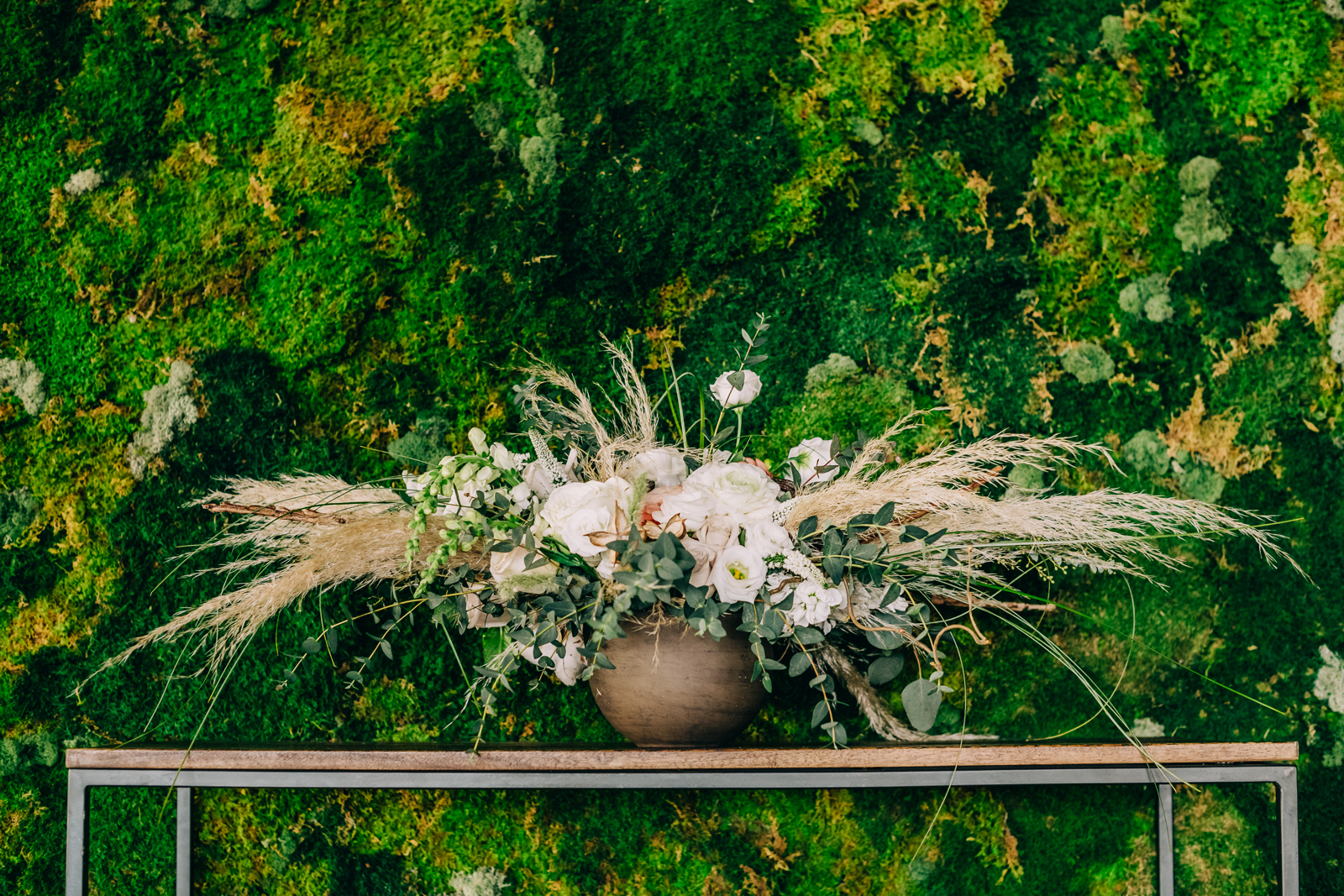 large floral arrangement in front of green bush