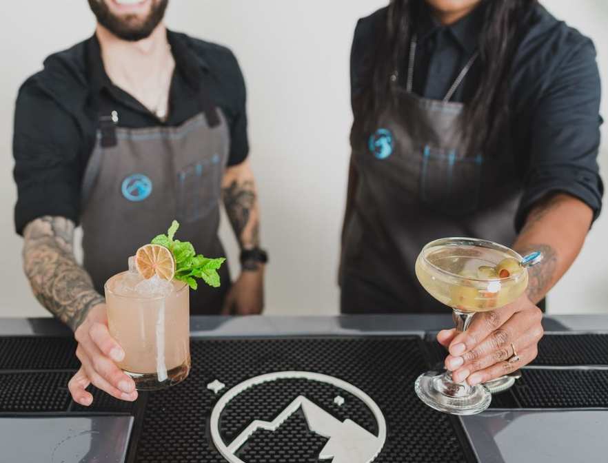 Bartenders serving cocktails